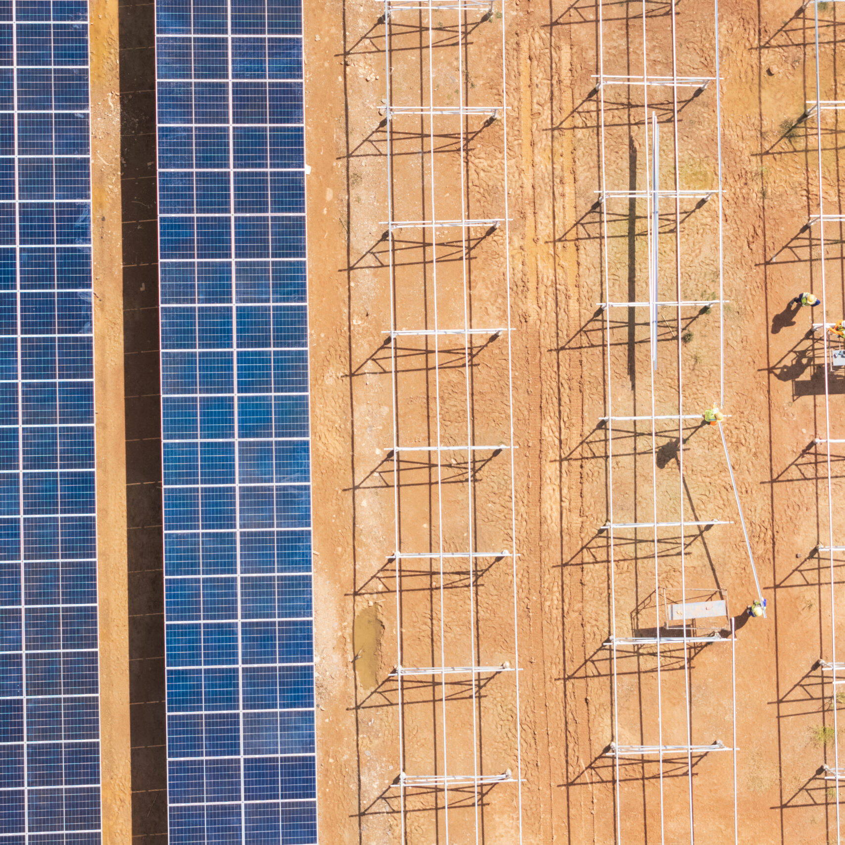 Aerial view of workers installing solar panels.